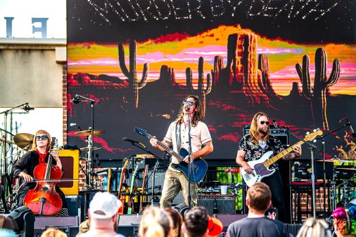 Band playing in front of light screen