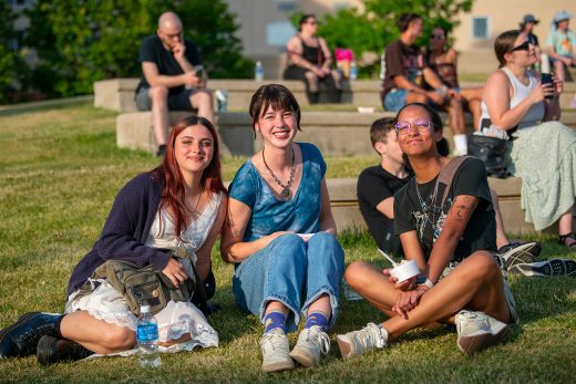 Group sitting on the grass smiling